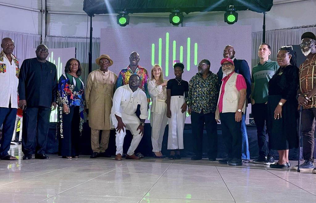 DJ Spices poses with Hoodtalk Foundation Leadership Team